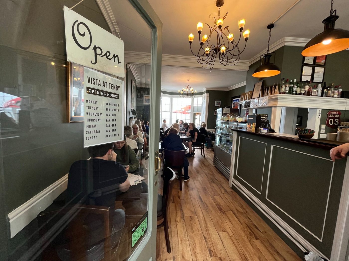 Inside Cafe Vista: the counter and dining room, with a chandelier